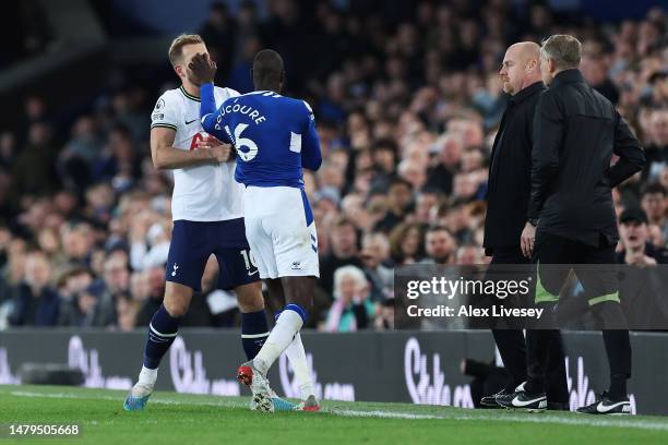 Harry Kane of Tottenham Hotspur and Abdoulaye Doucoure of Everton clash during the Premier League match between Everton FC and Tottenham Hotspur at...