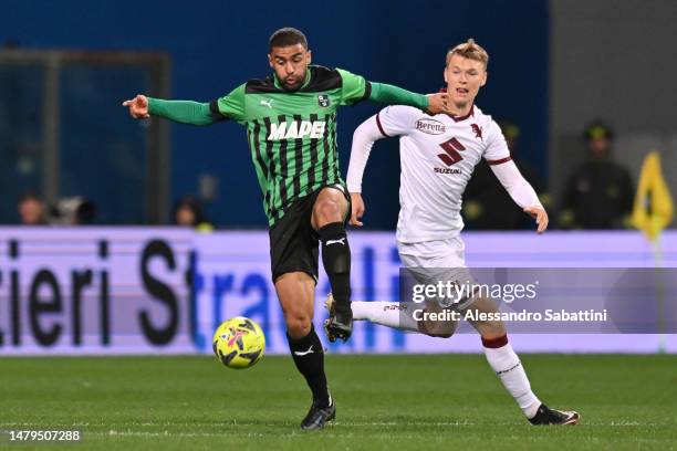 Gregoire Defrel of US Sassuolo is challenged by Perr Schuurs of Torino FC uring the Serie A match between US Sassuolo and Torino FC at Mapei Stadium...