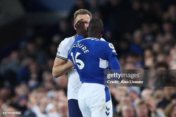 Harry Kane of Tottenham Hotspur and Abdoulaye Doucoure of Everton clash during the Premier League match between Everton FC and Tottenham Hotspur at...