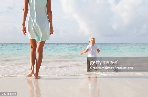 mother and toddler baby boy on beach - mother and child in water at beach stock pictures, royalty-free photos & images