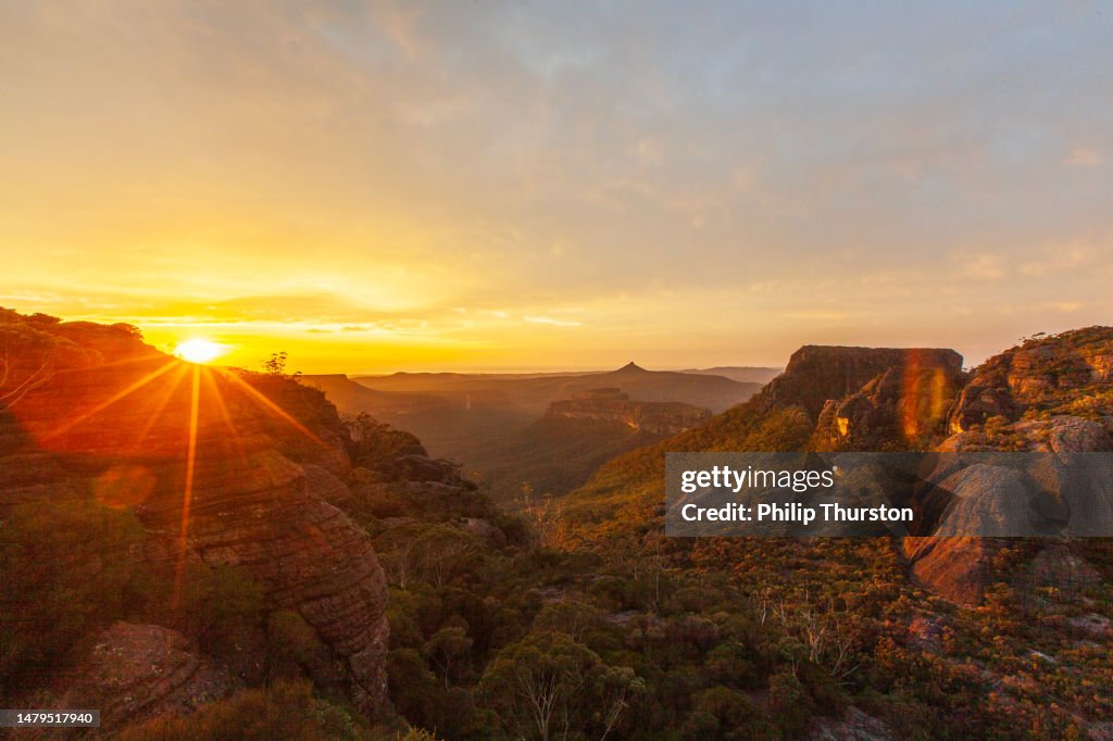 Sunrise over dramatic mountain landscape scene