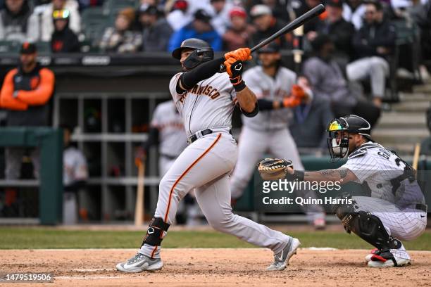 David Villar of the San Francisco Giants hits a grand slam home run in the ninth inning against the Chicago White Sox at Guaranteed Rate Field on...
