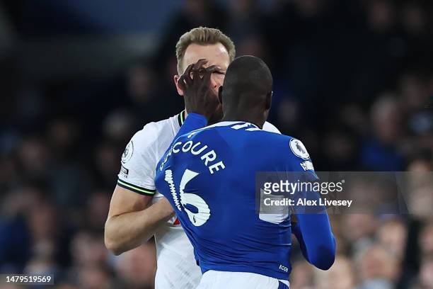 Harry Kane of Tottenham Hotspur and Abdoulaye Doucoure of Everton clash during the Premier League match between Everton FC and Tottenham Hotspur at...