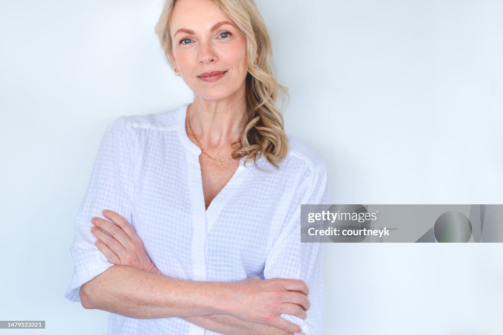 Attractive Mature woman looking strong and confident and relaxing and looking at the camera.