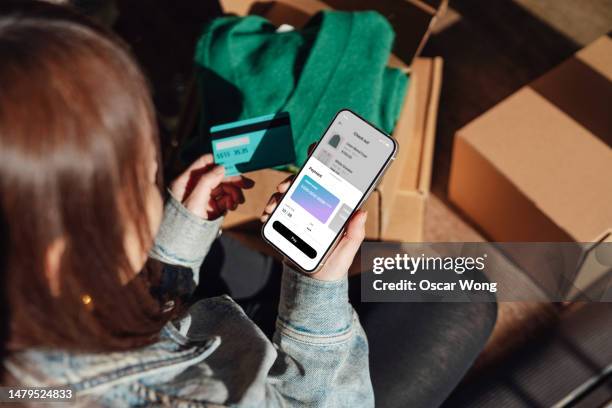 young woman making online payment on smartphone with credit card - express delivery stock pictures, royalty-free photos & images