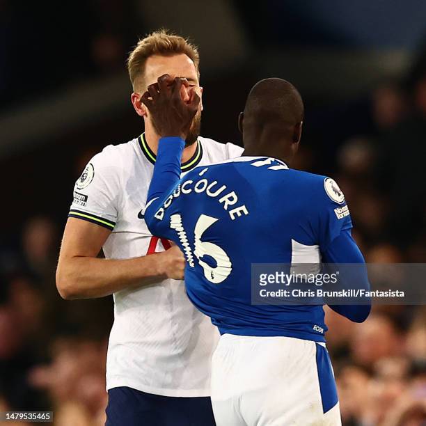 Abdoulaye Doucoure of Everton clashes with Harry Kane of Tottenham Hotspur during the Premier League match between Everton FC and Tottenham Hotspur...
