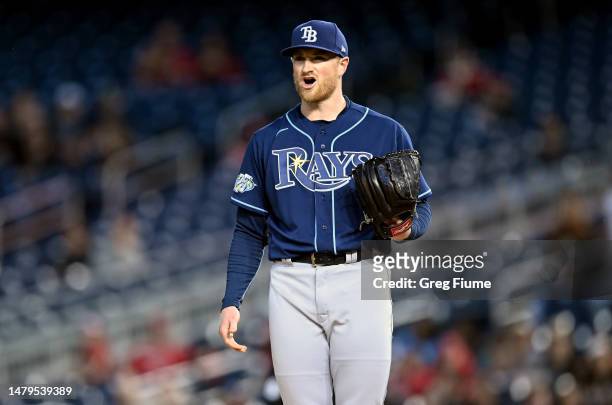 Drew Rasmussen of the Tampa Bay Rays reacts after being called for a pitch clock violation in the second inning against the Washington Nationals at...