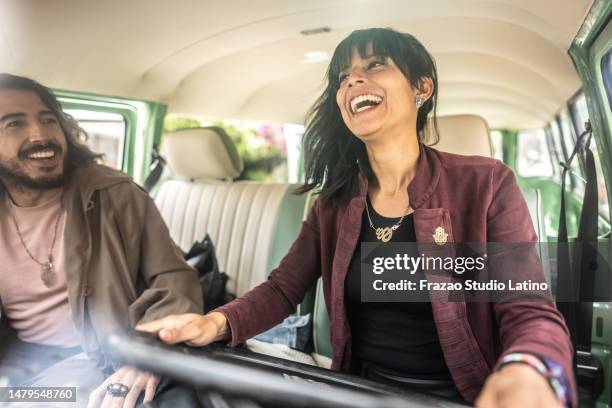 friends having fun on road trip in a retro mini van - alternative lifestyle stock pictures, royalty-free photos & images