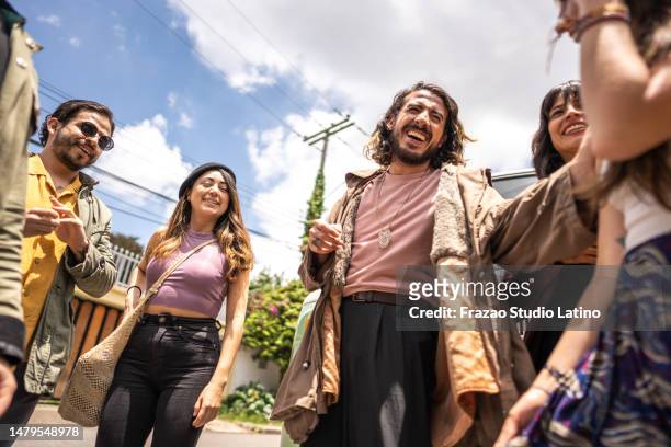 friends talking and having fun outdoors - street party stock pictures, royalty-free photos & images