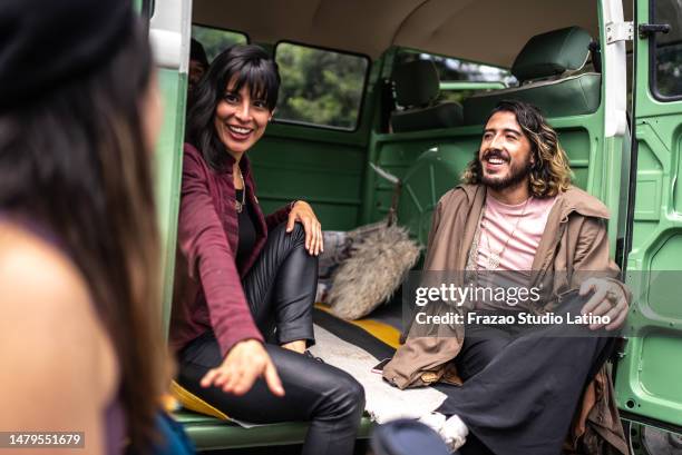 friends talking on a road trip in a retro mini van - camp gay venture imagens e fotografias de stock