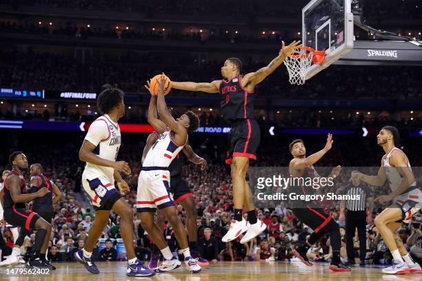 Keshad Johnson of the San Diego State Aztecs defends against Nahiem Alleyne of the Connecticut Huskies during the first half during the NCAA Men's...