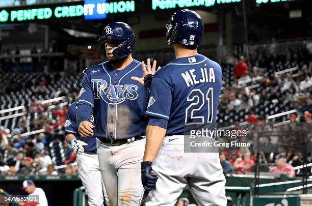 Isaac Paredes of the Tampa Bay Rays celebrates with Francisco Mejia after scoring in the ninth inning against the Washington Nationals at Nationals...