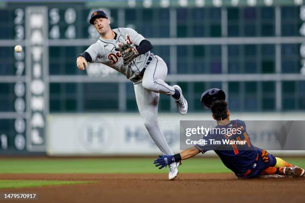 Ryan Kreidler of the Detroit Tigers turns a double play as Mauricio Dubon of the Houston Astros slides into second base in the eighth inning at...