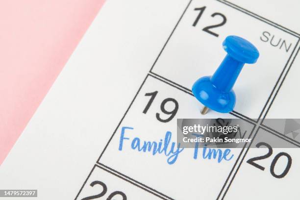 family time marked with a pin on a calendar to serve as a reminder of an important appointment. - agenda template stock pictures, royalty-free photos & images