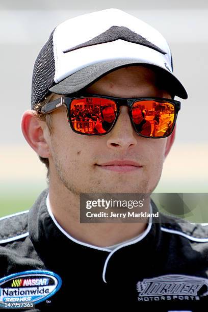 James Buescher, driver of the Ron Jon Surf Shop/Quicksilver Chevrolet, stands on the grid during qualifying for the NASCAR Nationwide Series Subway...