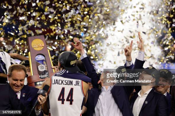 Head coach Dan Hurley of the Connecticut Huskies reacts as Andre Jackson Jr. #44 holds the championship trophy after defeating the San Diego State...