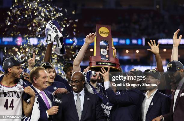 Head coach Dan Hurley of the Connecticut Huskies holds up the championship trophy after defeating the San Diego State Aztecs 76-59 during the NCAA...