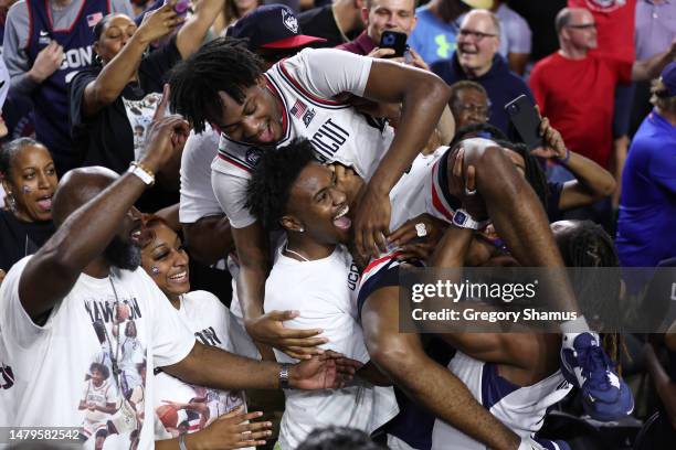 Tristen Newton of the Connecticut Huskies celebrates with teammates after defeating the San Diego State Aztecs 76-59 during the NCAA Men's Basketball...