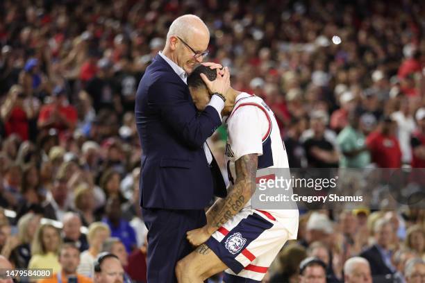 Head coach Dan Hurley of the Connecticut Huskies hugs a player during the second half San Diego State Aztecs during the NCAA Men's Basketball...