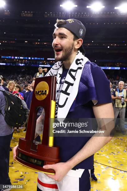 Alex Karaban of the Connecticut Huskies celebrates with the trophy after defeating the San Diego State Aztecs to win the NCAA Men's Basketball...
