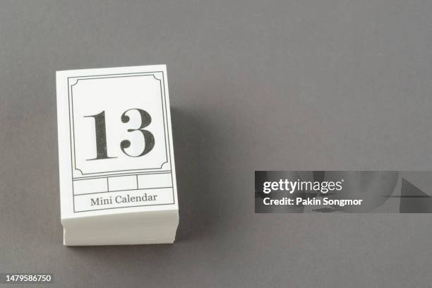 mini calendar with the date 13th on a gray background. - friday 13 stockfoto's en -beelden