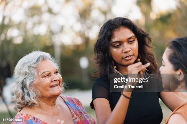 three generations of aboriginal australian women - australian aborigine culture stock pictures, royalty-free photos & images