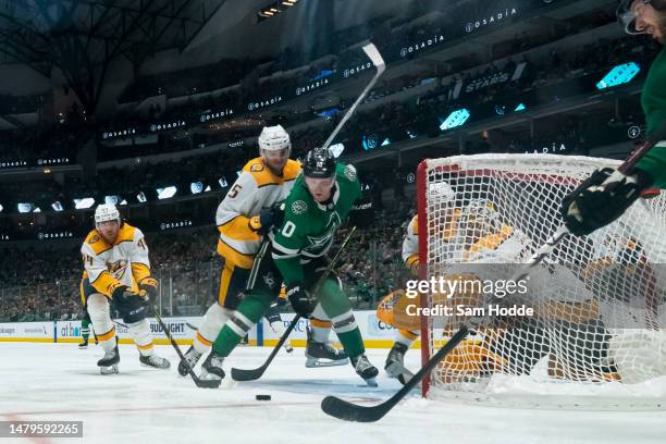 Ty Dellandrea of the Dallas Stars plays the puck in front of Juuse Saros of the Nashville Predators during the third period at American Airlines...