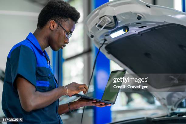 turner performance provides the ultimate performance advantage. males technician use the laptop with a green screen to check the vehicle after tuning it in the garage. - auto tuning stock pictures, royalty-free photos & images