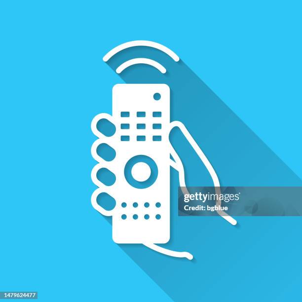 hand with remote control. icon on blue background - flat design with long shadow - remote control stock illustrations