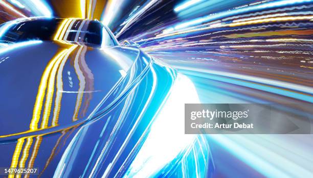 driving a futuristic car at night with extreme urban light trails and cool vanishing point effect. - vanuit een auto stockfoto's en -beelden