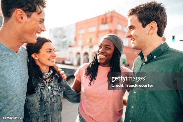 friends walking all together on venice beach - la four stock pictures, royalty-free photos & images