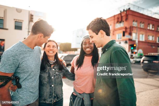 friends walking all together on venice beach - community arm in arm stock pictures, royalty-free photos & images