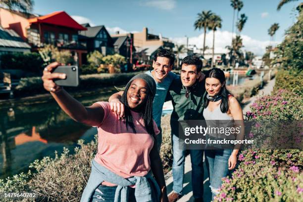 friends doing a selfie on the venice canals - la italia stock pictures, royalty-free photos & images