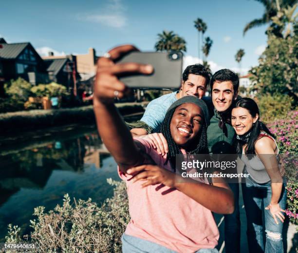 friends doing a selfie on the venice canals - la italia stock pictures, royalty-free photos & images