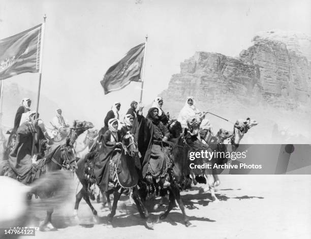 Peter O'Toole leads a group of men on camel back in a scene from the film 'Lawrence Of Arabia', 1962.