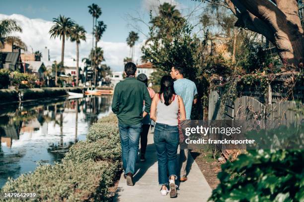 friends walking all together on venice beach - la four stock pictures, royalty-free photos & images