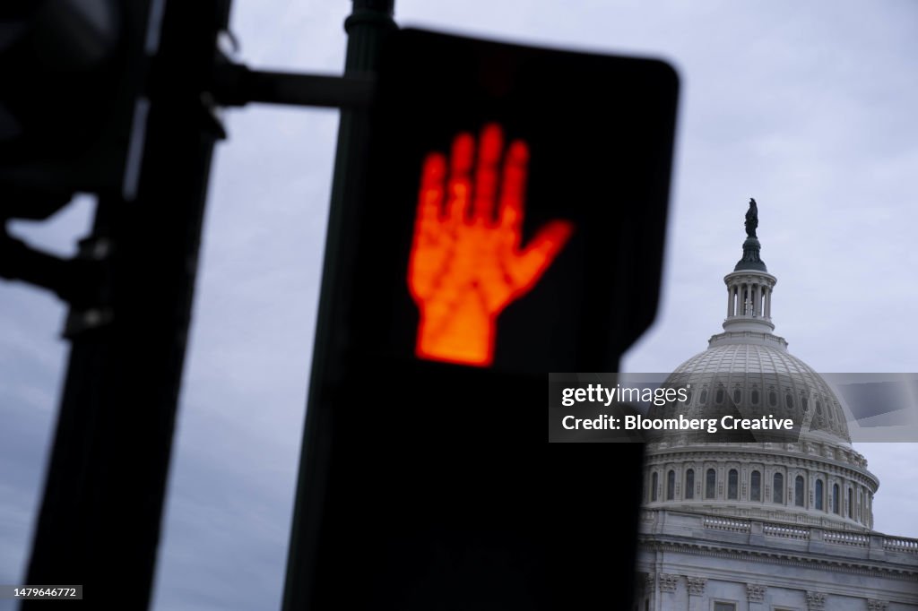 A Red Stop Sign In Front Of The US Capitol Building