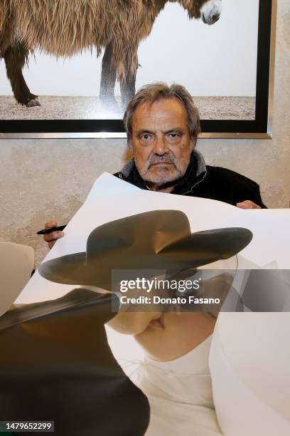 Photographer Oliviero Toscani with a copy of his photograph of a priest and a nun kissing on April 03, 2023 in Monopoli, Italy. Promoted by the...