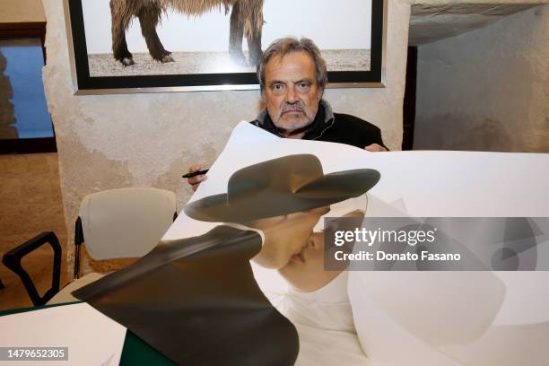 Photographer Oliviero Toscani with a copy of his photograph of a priest and a nun kissing on April 03, 2023 in Monopoli, Italy. Promoted by the...