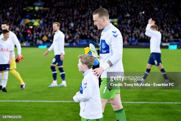 Jordan Pickford of Everton walks out with mascot Harry before the Premier League match between Everton FC and Tottenham Hotspur at Goodison Park on...