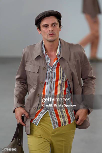 Model walks the runway during the Agnes B Menswear Spring / Summer 2013 show as part of Paris Fashion Week at Maison des Metallos on July 1, 2012 in...