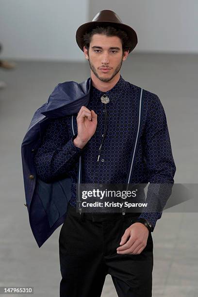 Model walks the runway during the Agnes B Menswear Spring / Summer 2013 show as part of Paris Fashion Week at Maison des Metallos on July 1, 2012 in...