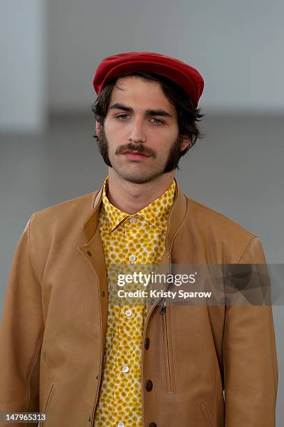 Model walks the runway during the Agnes B Menswear Spring / Summer 2013 show as part of Paris Fashion Week at Maison des Metallos on July 1, 2012 in...