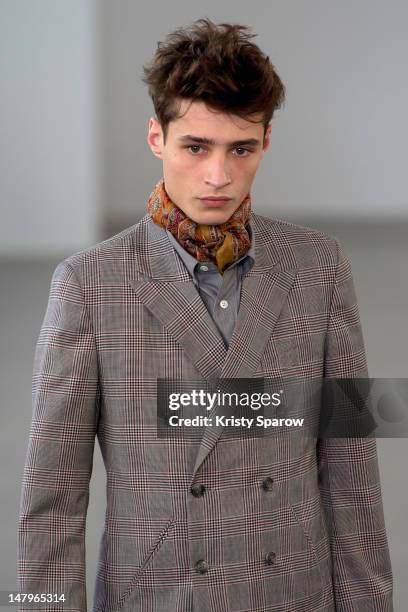 Model walks the runway during the Agnes B Menswear Spring / Summer 2013 show as part of Paris Fashion Week at Maison des Metallos on July 1, 2012 in...