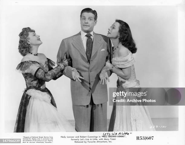 Robert Cummings is pulled on by Anna Sten and Hedy Lamarr in a scene from the film 'Let's Live A Little', 1948.