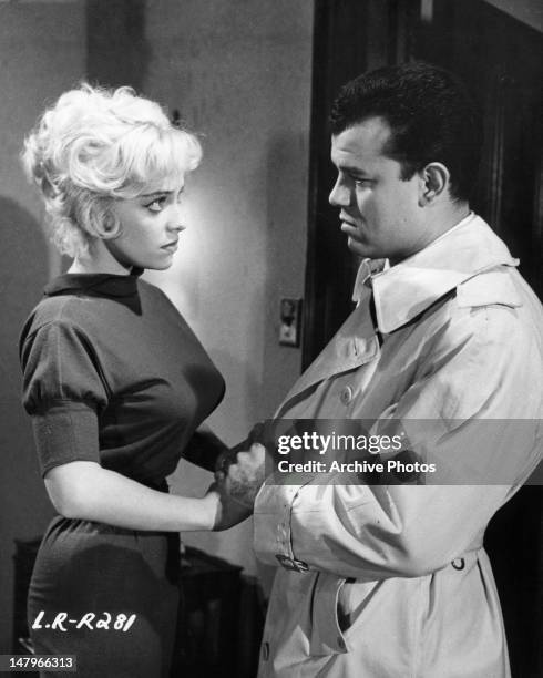 Julius LaRosa resists the advances of pick-up girl Joy Harmon in a scene from the film 'Let's Rock', 1958.