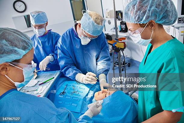 surgical team beginning plastic surgery procedure - plastic surgeon stock pictures, royalty-free photos & images