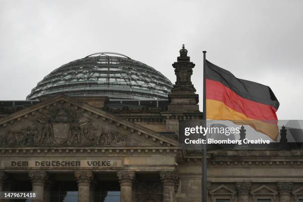 german flag by the reichstag building - german stock pictures, royalty-free photos & images