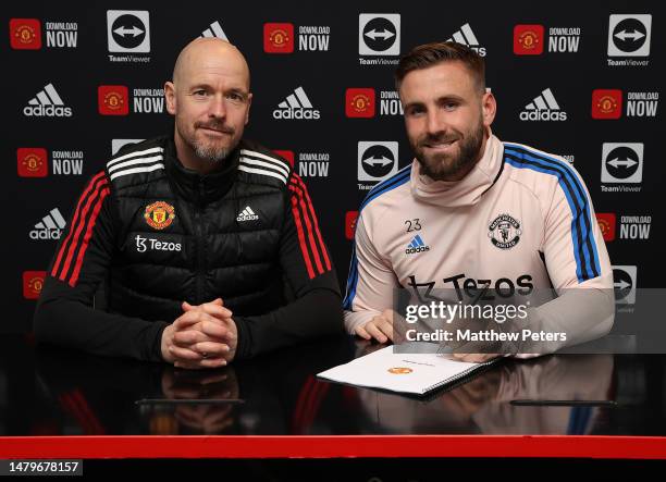 Luke Shaw of Manchester United poses after signing a new contract with the club at Carrington Training Ground on April 4, 2023 in Manchester, England.