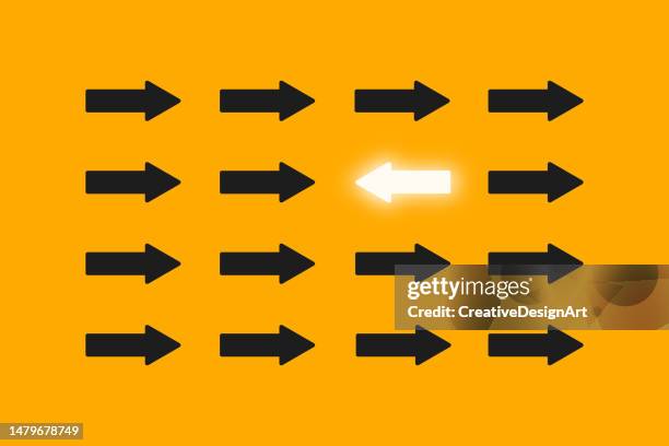 standing out from the crowd, think differently, individuality and leadership concept with white arrow goes in a different direction from the black arrows - unleash stock illustrations